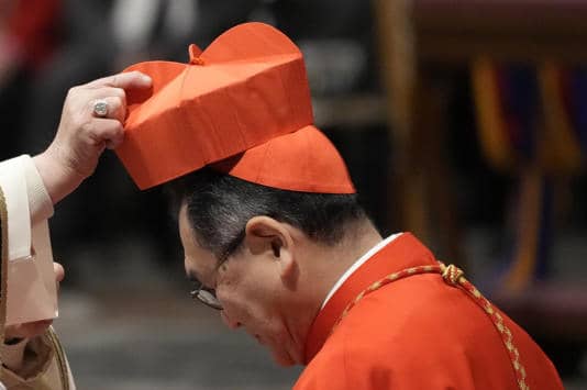 Cardinal Tarcisio Isao Kikuchi, Archbishop of Tokyo, Japan, right, receives his cardinal’s biretta from Pope Francis in St. Peter's Basilica at The Vatican on Dec. 7, 2024. (Credit: Gregorio Borgia/AP.)