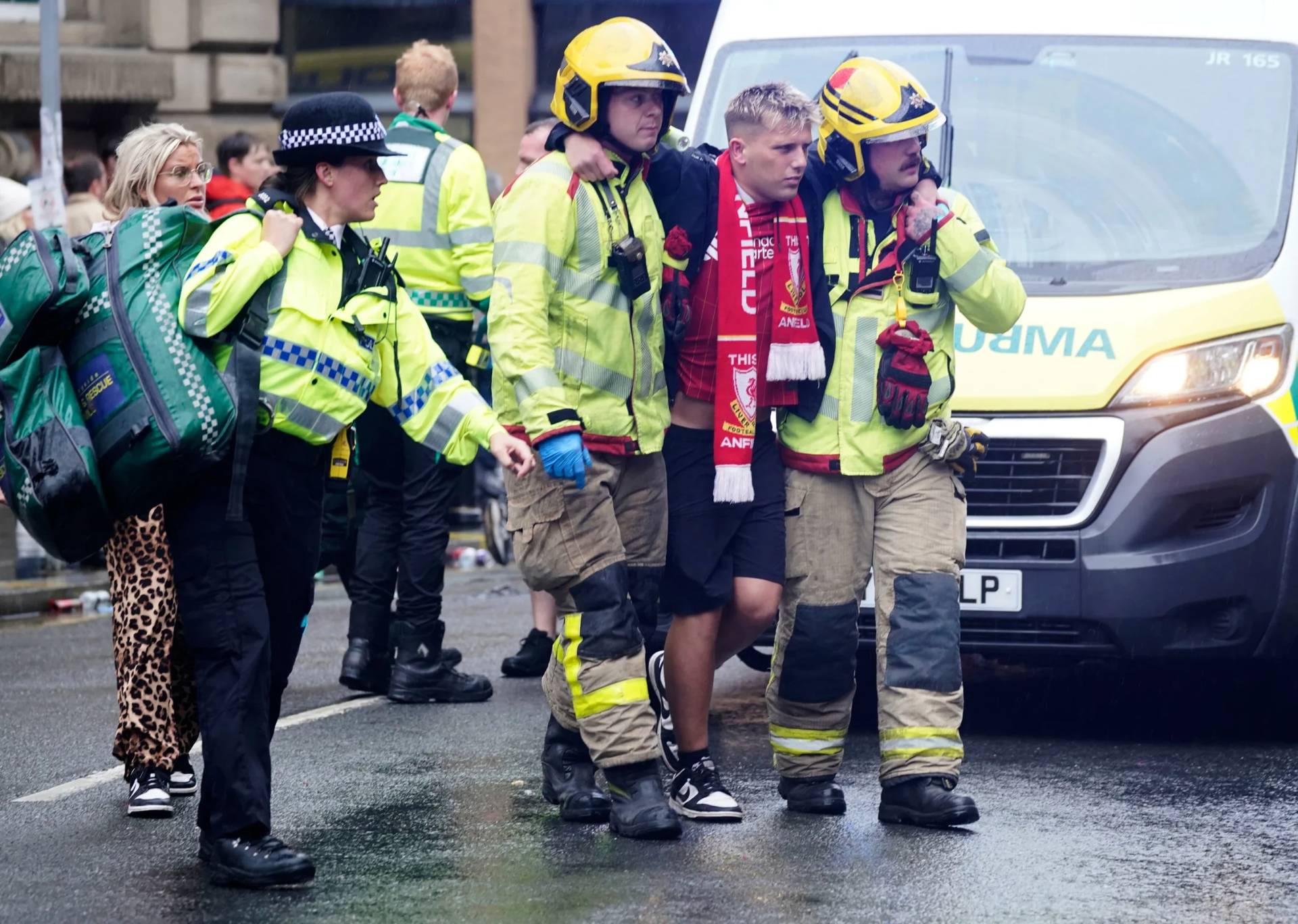 Police and emergency personnel deal with the injured after a car plows into people at a soccer celebration in Liverpool, England on May 26, 2025. (Credit: Owen Humphreys/PA via AP.)