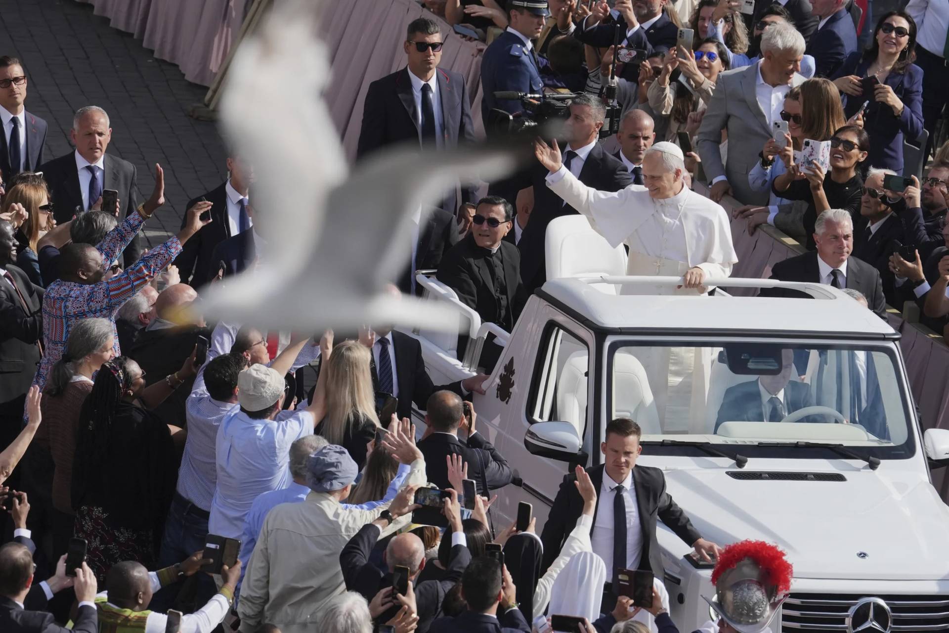 A bird flies by as Pope Leo XIV tours St. Peter’s Square on his popemobile on May 18, 2025. (Credit: Jaquelyn Martin/Pool via AP.)