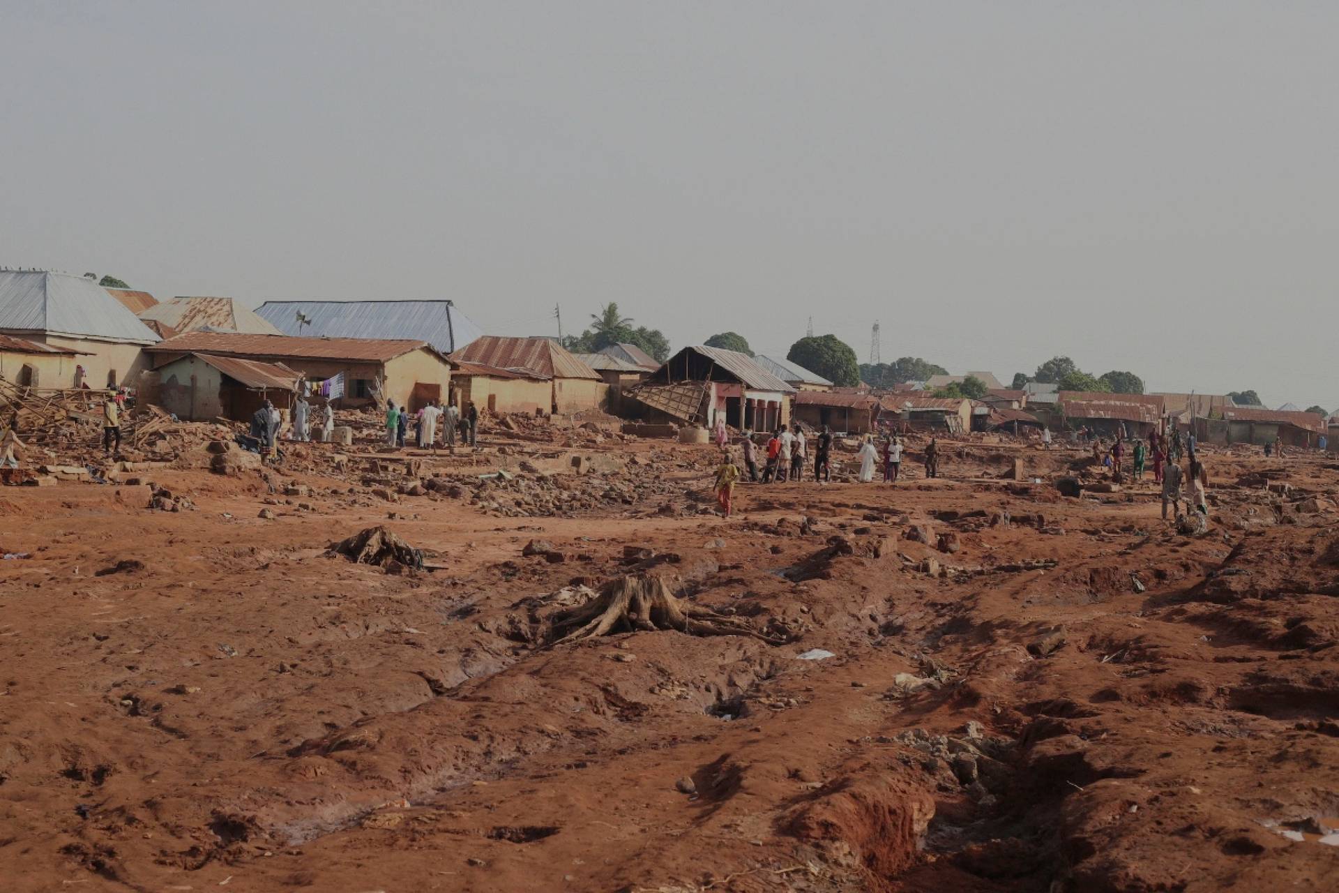 People gather in a flooded area of a market area in Mokwa, in north central Nigeria, on May 31, 2025. (Credit: Usman Salihu Mokwa/AP.)