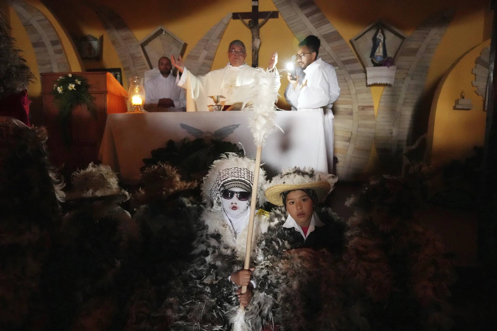 Children dressed in feather costumes attend a Mass celebrating Saint Francisco Solano at his namesake chapel in Emboscada, Paraguay, Thursday, July 24, 2025. Catholic parishioners in Paraguay don bird-like costumes and parade the streets to honor the 16th century saint said to possess miraculous powers. (Credit: Jorge Saenz/AP.)