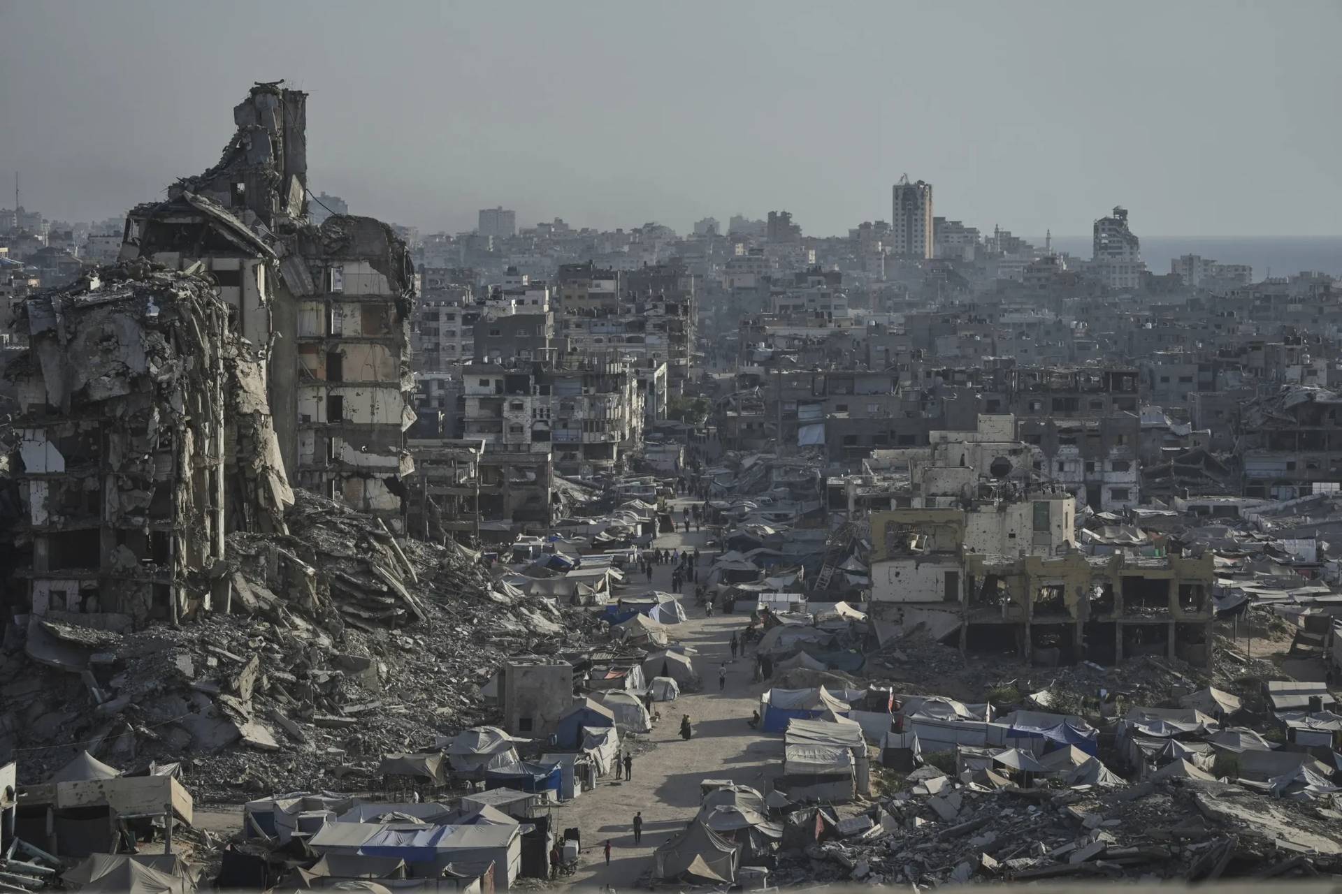 Tents sheltering displaced Palestinians are seen amid war-damaged infrastructure in Gaza City, Thursday, July 17, 2025. (Credit: Jehad Alshrafi/AP.)