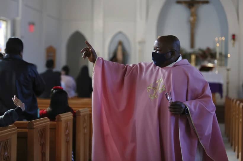 Father Athanasius Abanulo waves to his parishioners after Mass on Dec. 12, 2021, at Immaculate Conception Catholic Church in Wedowee, Alabama. (Credit: Jessie Wardarski/AP.)