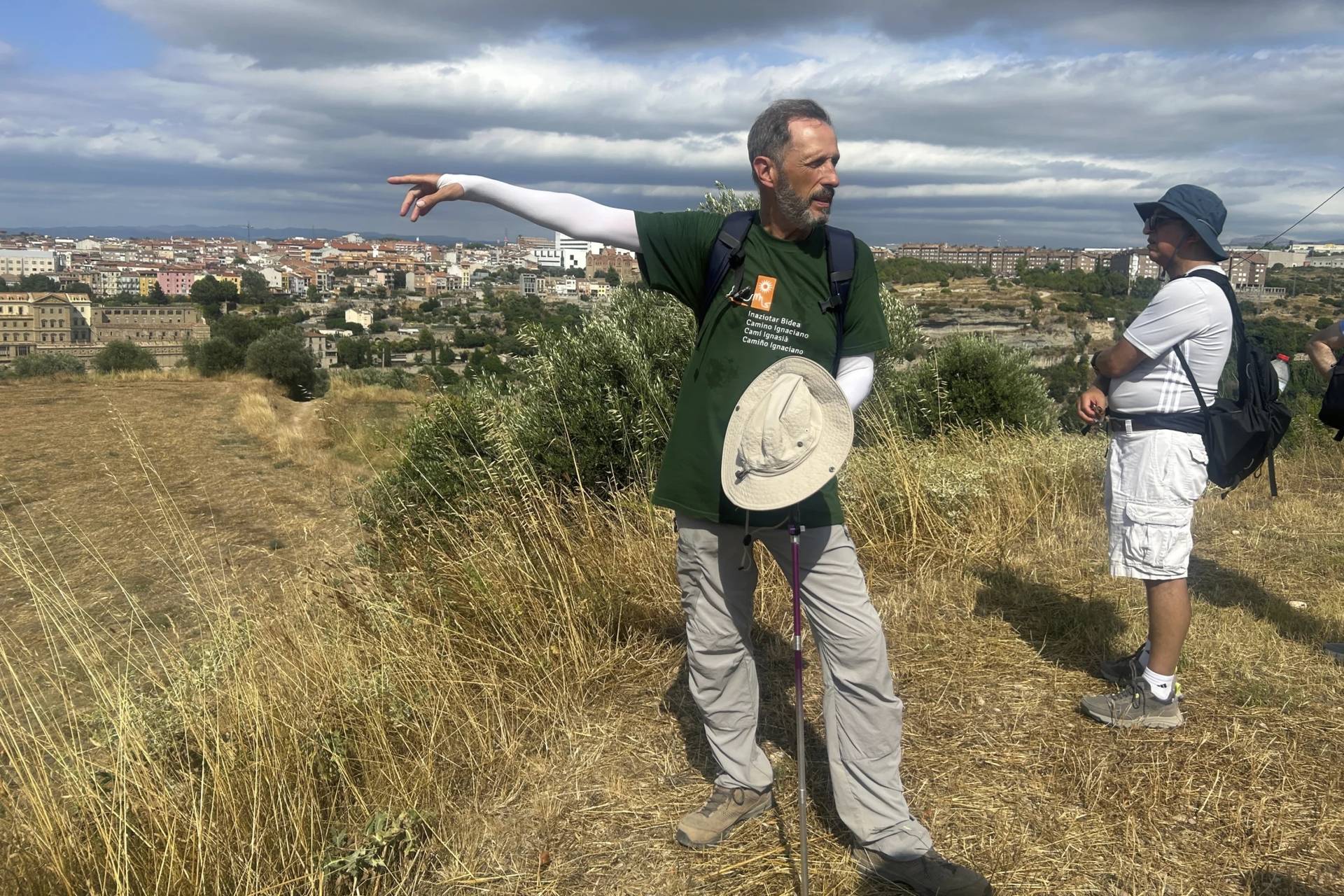 Jesuit Father Josep Lluís Iriberri points towards Manresa, where his group of pilgrims will conclude the Ignatian way pilgrimage, in Spain on July 9, 2025. (Credit: Joseph Wilson/AP.)