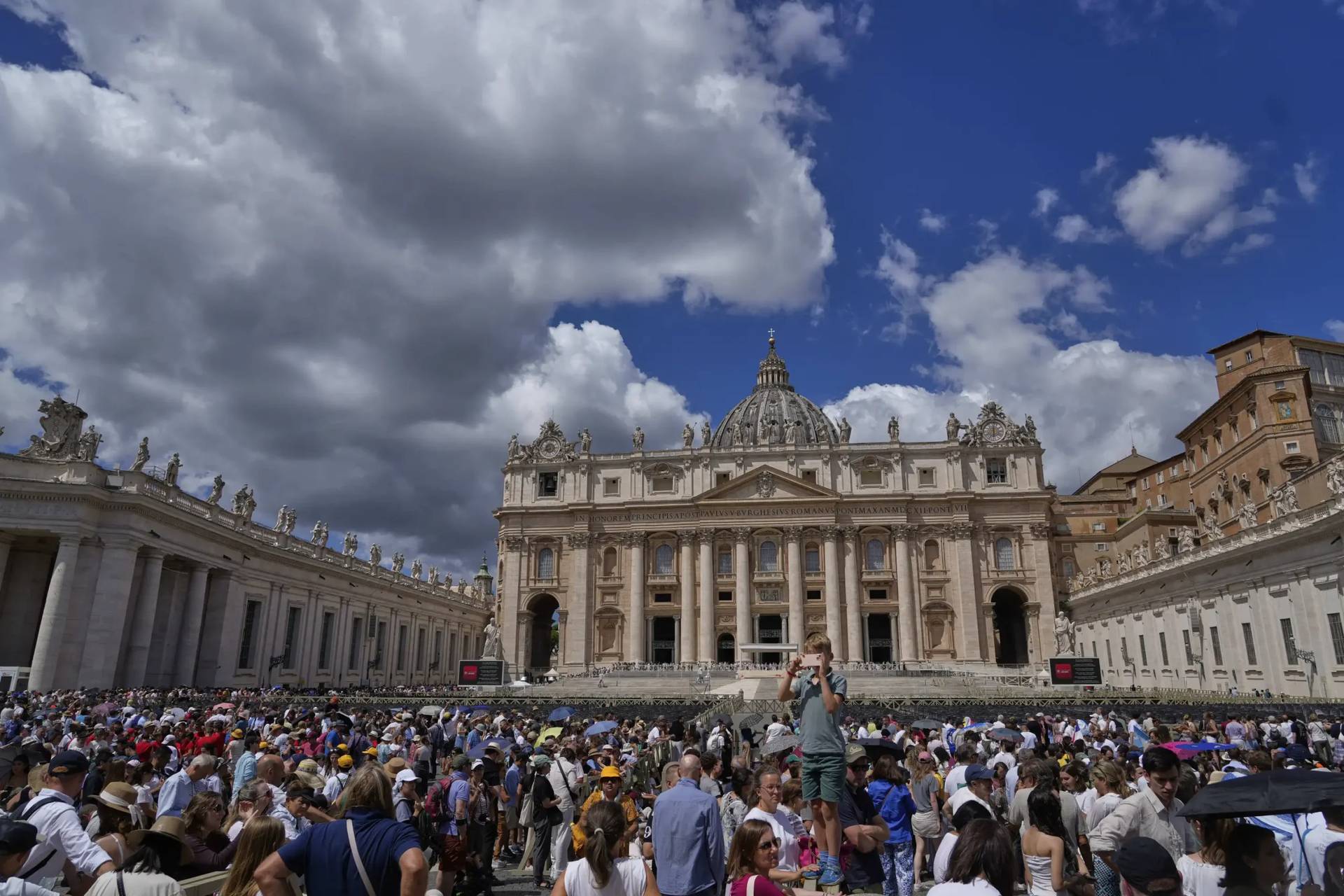 People wait for the Angelus by Pope Leo XIV on July 27 in St. Peter's Square. (Credit: Gregorio Borgia/AP.)