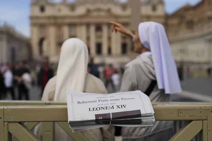 Nuns stand next to copies of L’Osservatore Romano newspaper with headlines in Latin of Pope Leo XIV at the Vatican, Friday, May 9, 2025, a day after he was elected as the first North American pope. (Credit: Francisco Seco/AP.)