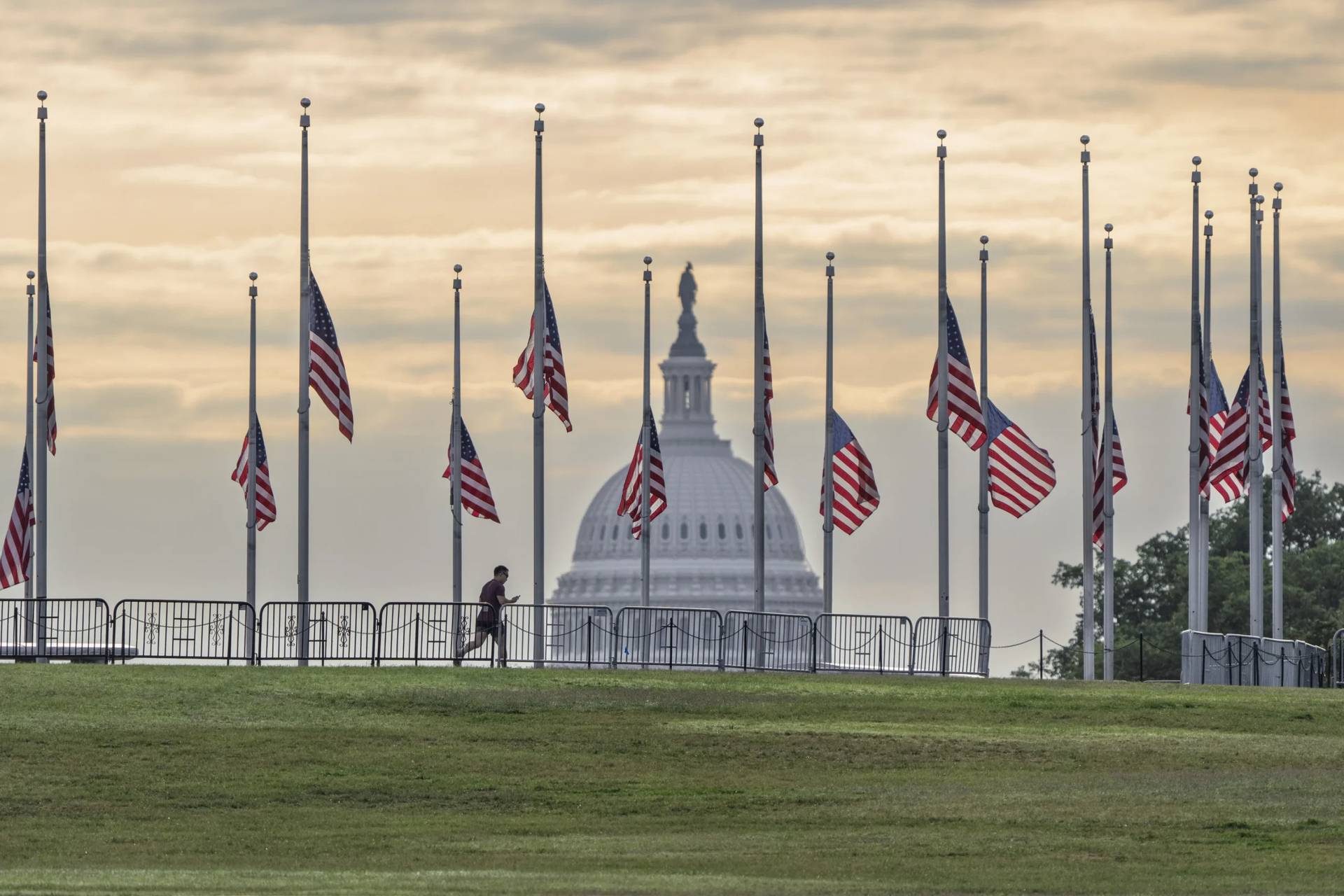 The flags circling the Washington Monument fly at half-staff in Washington, Thursday, Aug. 28, 2025, following the shooting at a Catholic church in Minneapolis. (Credit: J. Scott Applewhite/AP.)