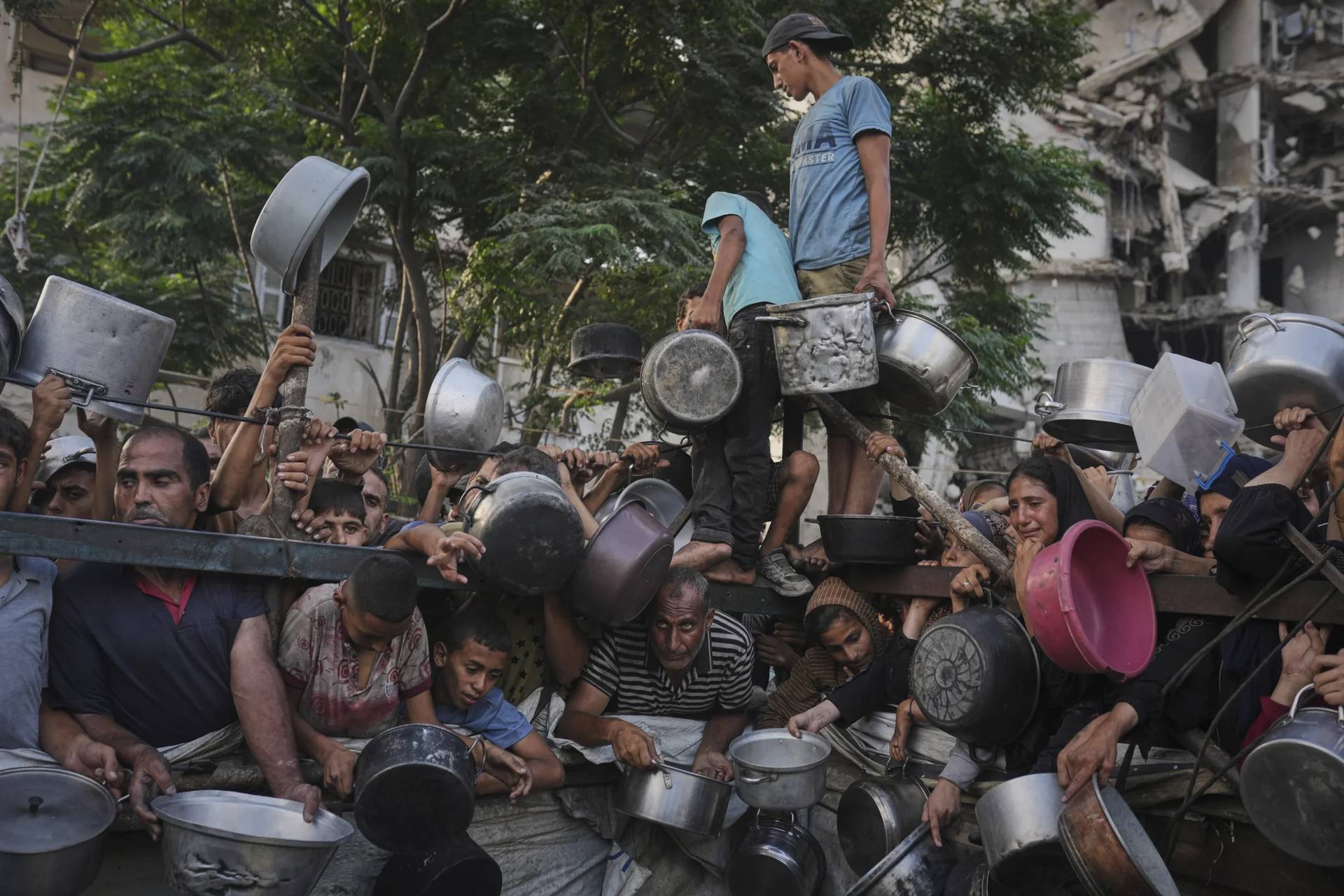 Palestinians struggle to get donated food at a community kitchen in Gaza City, northern Gaza Strip, July 14, 2025. (Credit: Jehad Alshrafi/AP.)