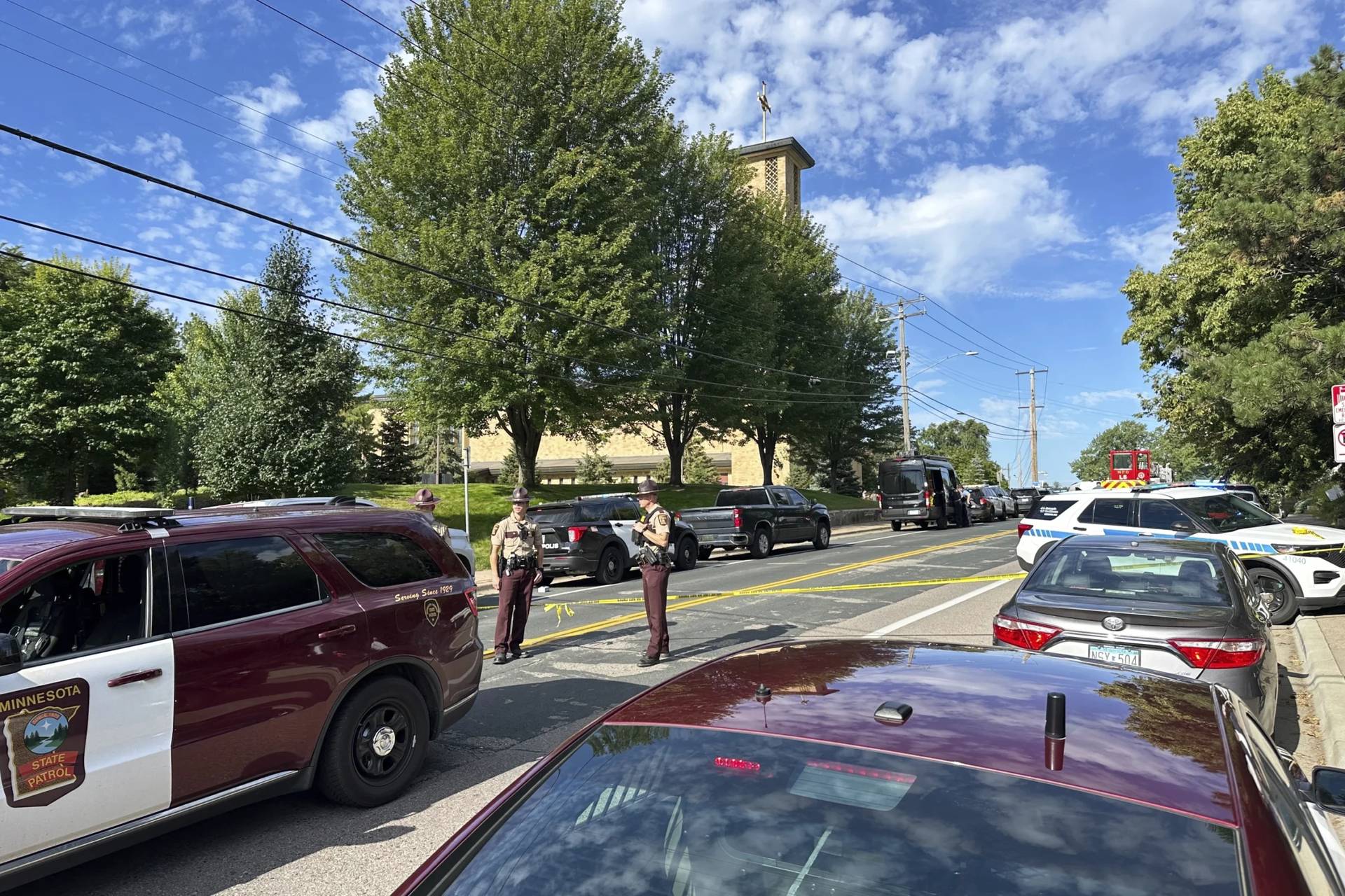 Law enforcement officers gather outside the Annunciation Church’s school in response to a reported mass shooting, Wednesday, Aug. 27, 2025, in Minneapolis. (Credit: Mark Vancleave/AP.)