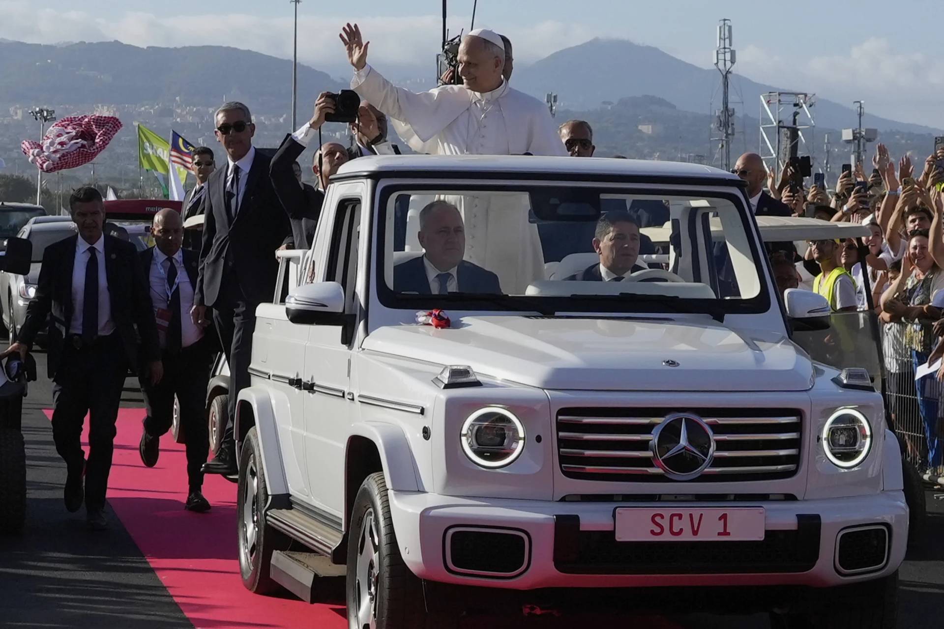A faithful throws a keffiyeh as Pope Leo XIV arrives for a Mass with young people participating in the Youths Jubilee at the Tor Vergata field in Rome, Sunday, Aug. 3, 2025. (Credit: Gregorio Borgia/AP.)