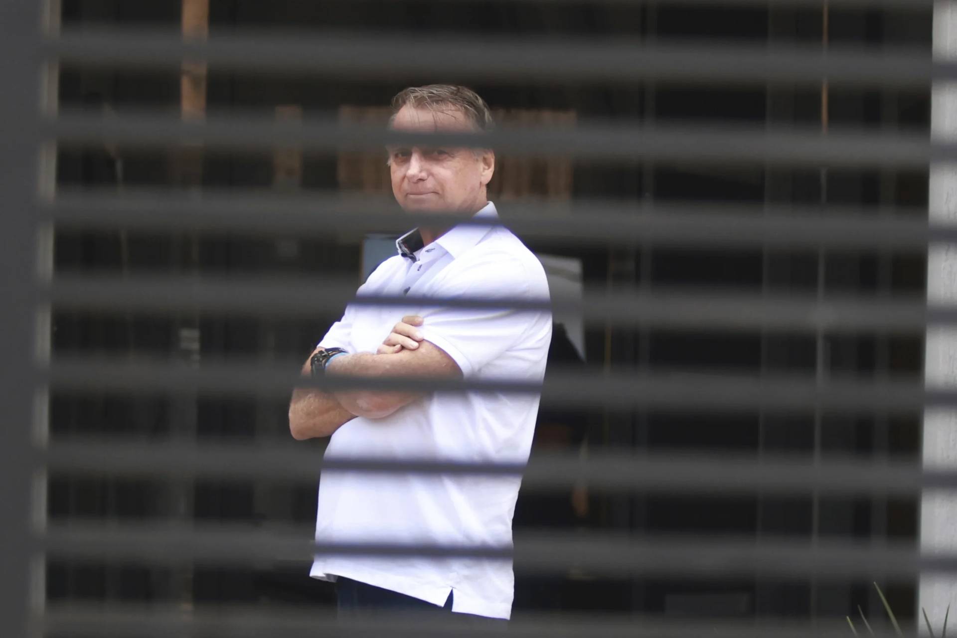 Brazil’s former President Jair Bolsonaro stands at the entrance of his home where he is under house arrest in Brasilia, Brazil, Tuesday, Sept. 2, 2025. (Credit: Luis Nova/AP.)