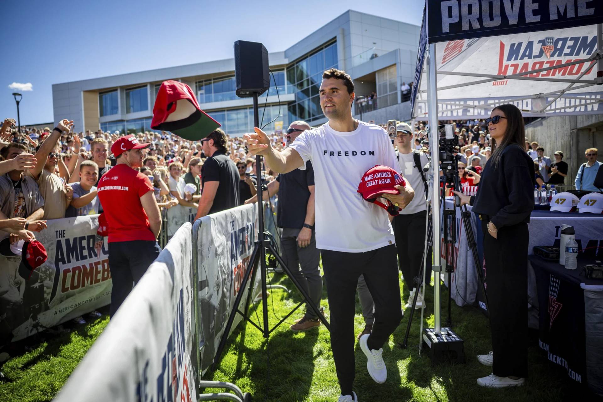 Charlie Kirk hands out hats before speaking at Utah Valley University in Orem, Utah, Wednesday, Sept. 10, 2025. (Credit: Tess Crowley/The Deseret News via AP.)