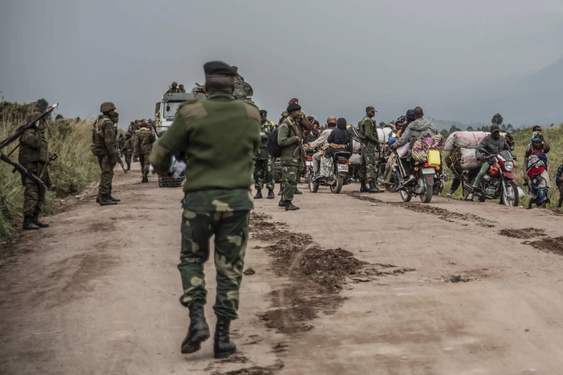 People walk on the road near Kibumba, north of Goma, in the Democratic Republic of Congo on May 24, 2022. (Credit: Moses Sawasawa/AP.)