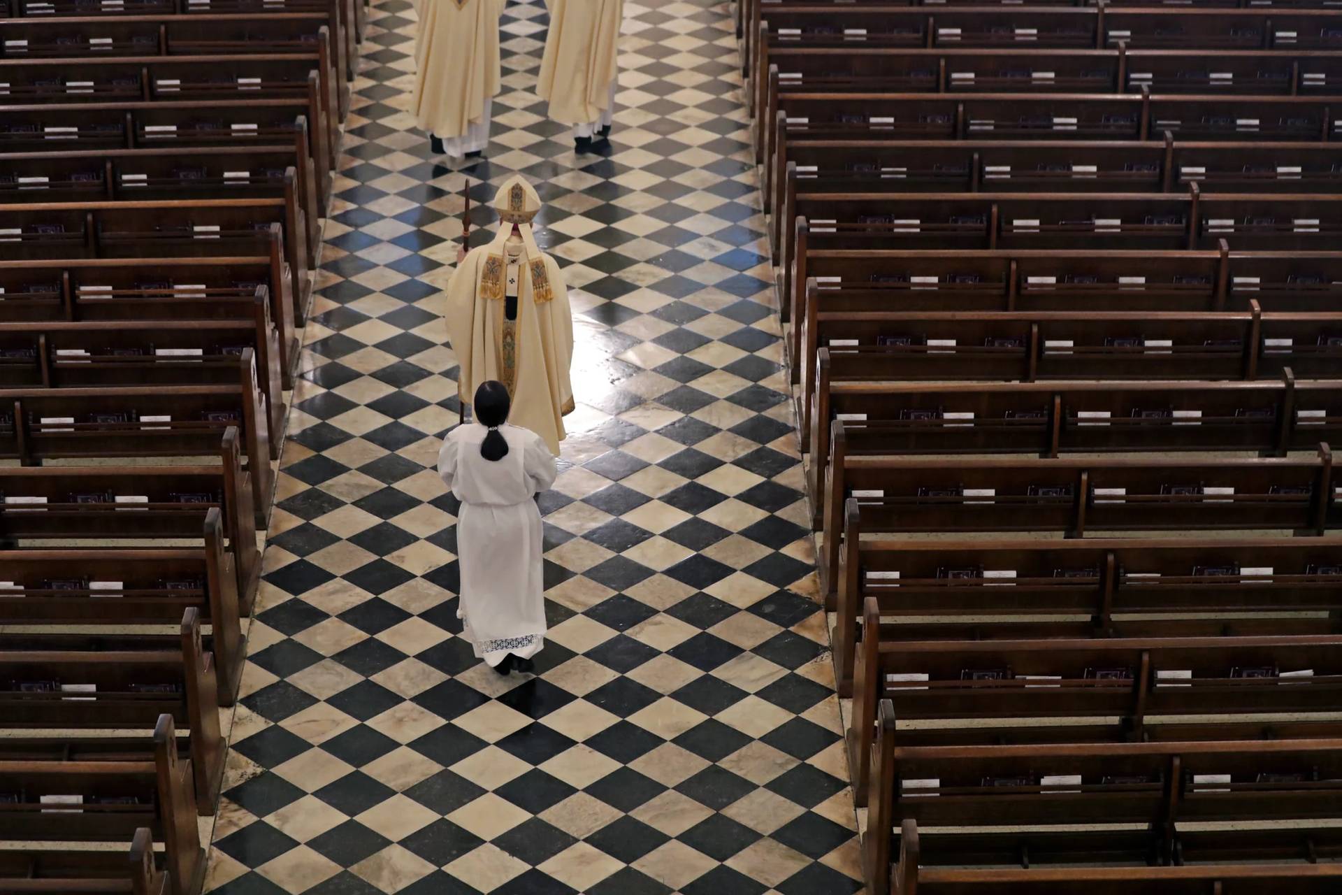 Archbishop Gregory Aymond conducts the procession of a Mass on April 12, 2020. (Credit: Gerald Herbert/AP.)