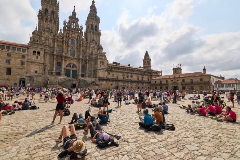Pilgrims and tourists rest in front of the cathedral in Santiago de Compostela, northwestern Spain, Thursday, Aug. 21, 2025. (Credit: Lalo Villar/AP.)
