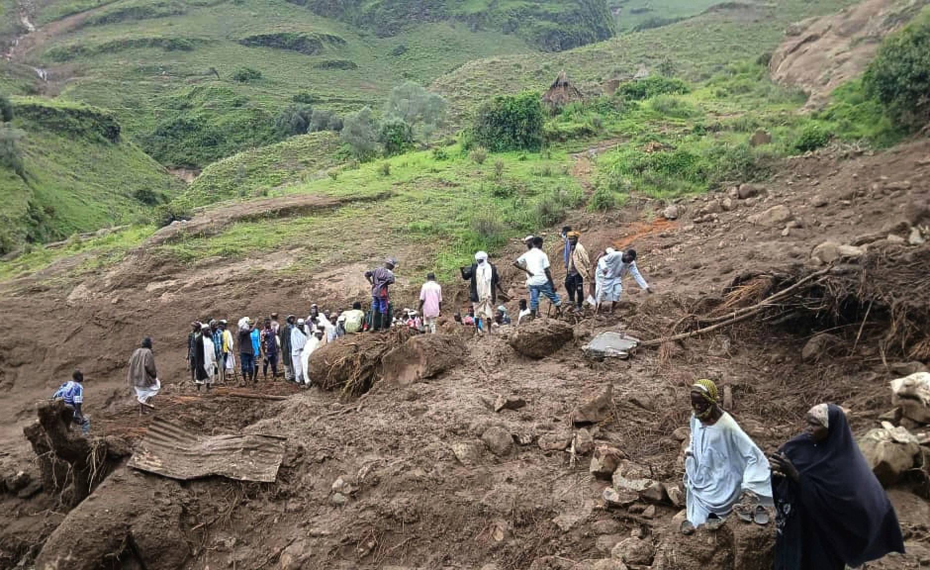 In this Monday, Sept. 1, 2025, photo provided by the Sudan Liberation Movement/Army, people gather at the site of a landslide from Aug. 31, that wiped out the village of Tarasin in the Marrah Mountains of Central Darfur, Sudan. (Credit: Sudan Liberation Movement/Army via AP.)