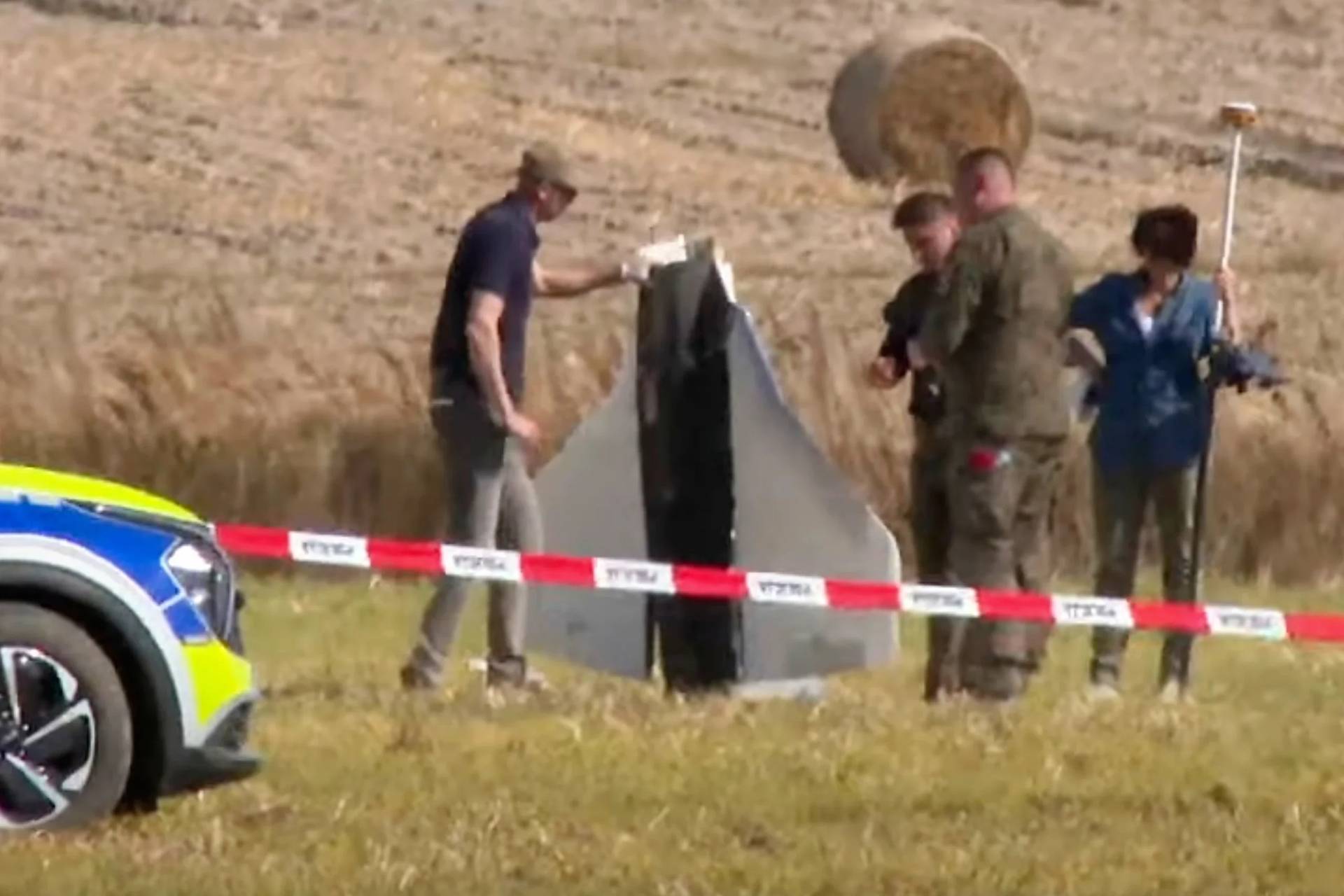 In this image made from video, Police and Military Police secure parts of a damaged object shot down by Polish authorities at a site in Wohyn, Poland, Wednesday, Sept. 10, 2025. (Credit: Rafal Niedzielski/AP.)