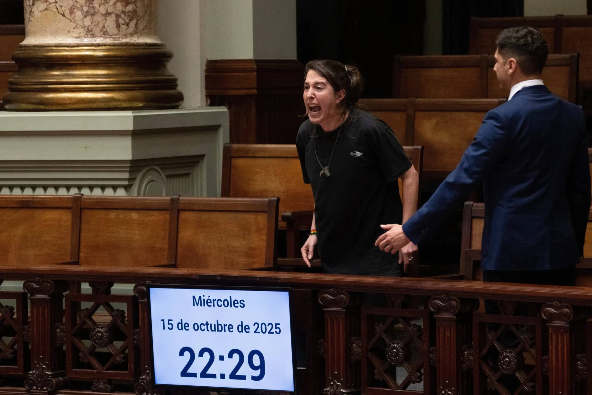 A woman shouts, “Murderers” in Spanish after Uruguay’s senate passed a law decriminalizing euthanasia, in Montevideo, Uruguay, Wednesday, Oct. 15, 2025. (Credit: Matilde Campodonico/AP.)