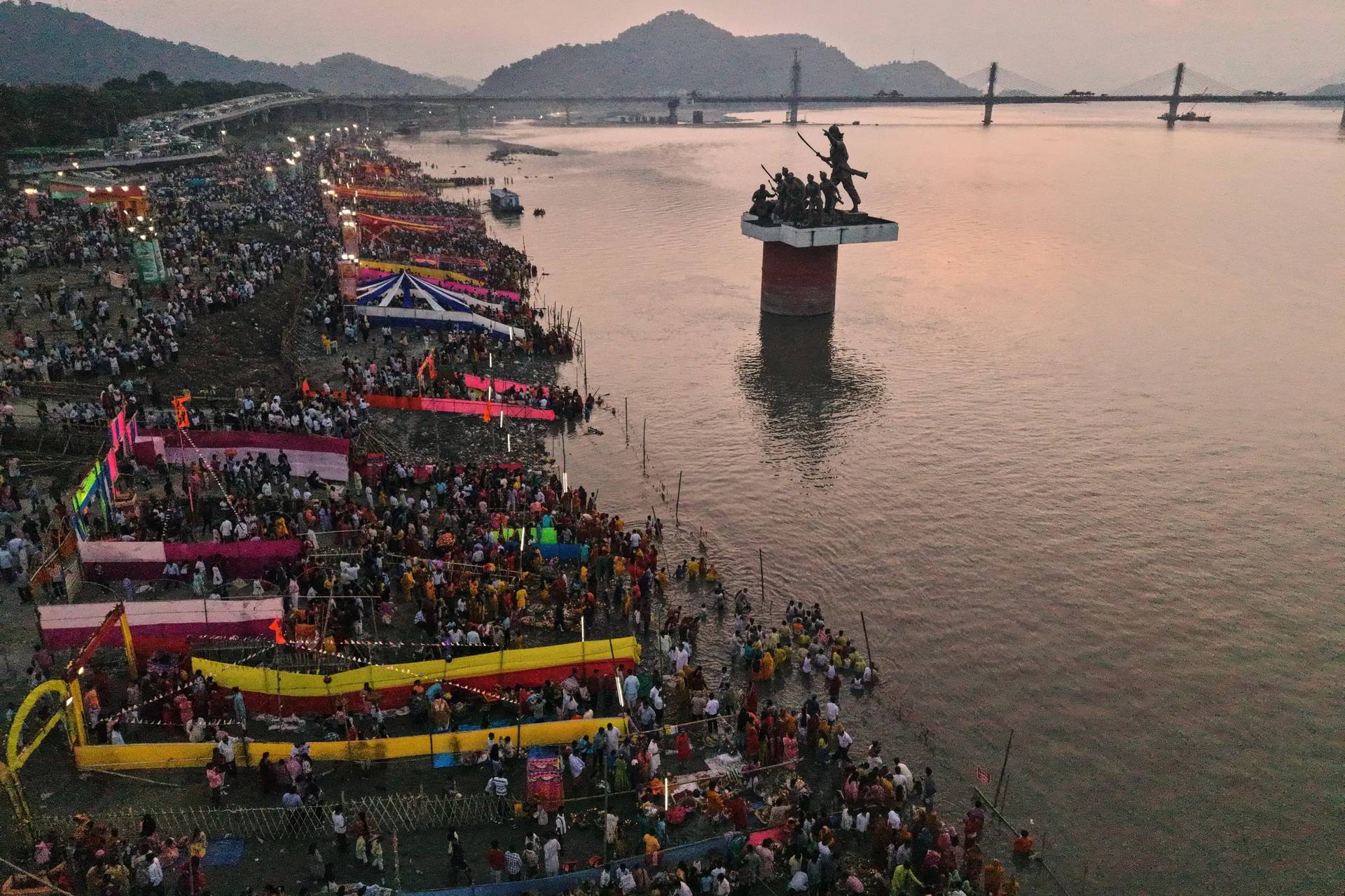 Indian Hindu devotees perform rituals in the the river Brahmaputra during the Chhath Puja festival in Guwahati, India, Monday, Oct. 27, 2025. (Credit: Anupam Nath/AP.)