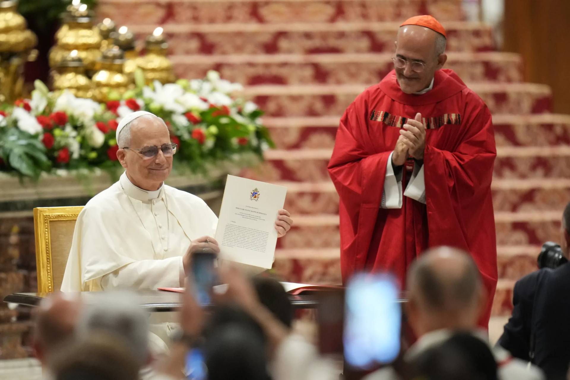 Pope Leo XIV, flanked by Cardinal Jose Tolentino de Mendonca, right, shows the apostolic letter on education before celebrating a Mass for the opening of the academic year of the Pontifical University and for the Jubilee of the Educational World in St. Peter's Basilica at the Vatican, Monday, Oct. 27, 2025.(Credit: Alessandra Tarantino/AP.)