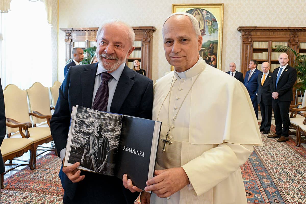 Pope Leo XIV meets Brazilian President Luiz Lula da Silva in the library of the Apostolic Palace at the Vatican Oct. 13, 2025. Lula holds a book with a black and white photo representing the Asháninka, an Indigenous people living in the rainforests in Brazil and Peru. (Credit: Vatican Media.)
