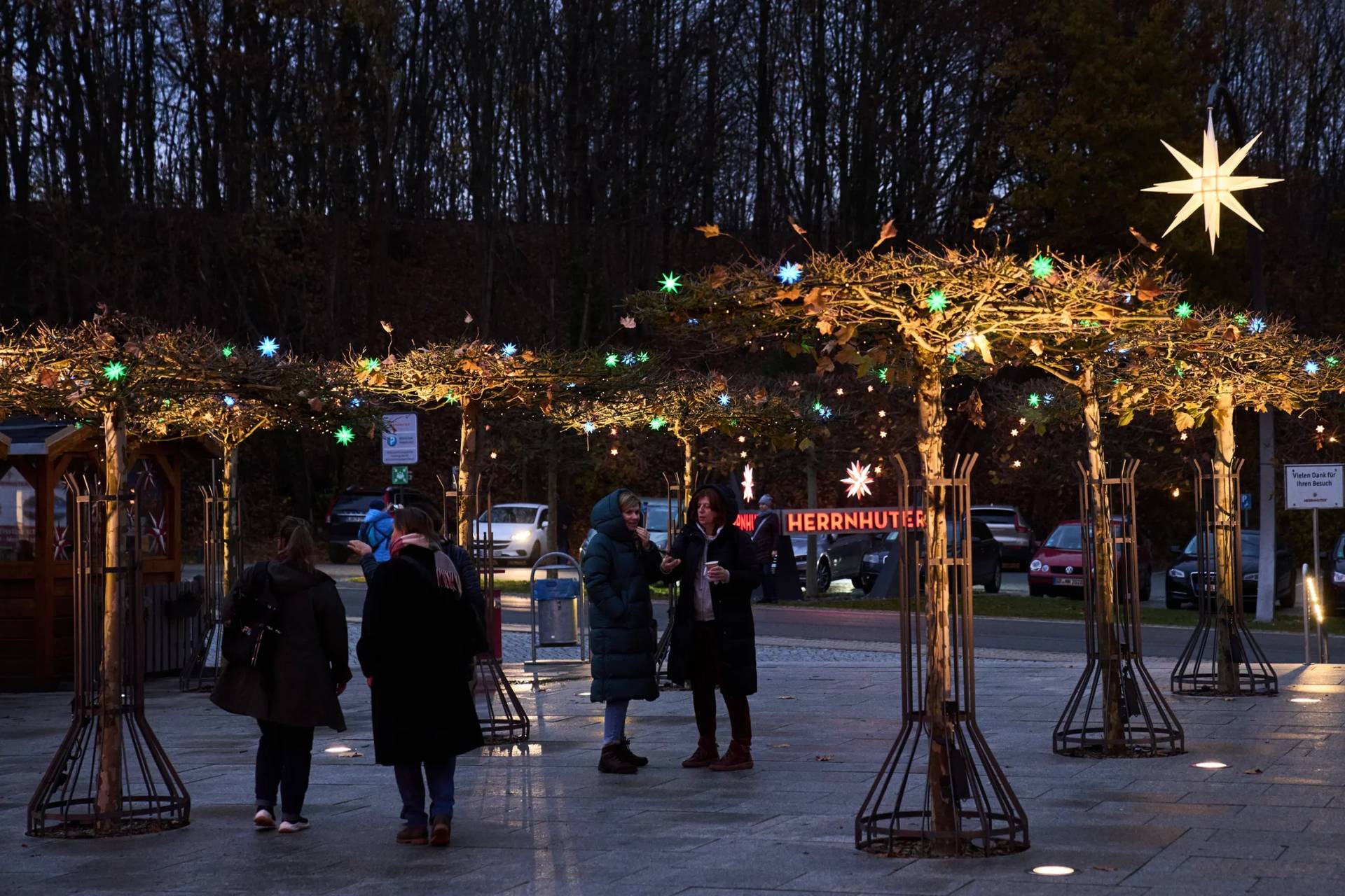 People visit Herrnhuter Sterne GmbH manufacturing, a Christmas stars manufacturing company in Herrnhut, Germany, Nov. 10, 2025. (Credit: Ebrahim Noroozi/AP.)