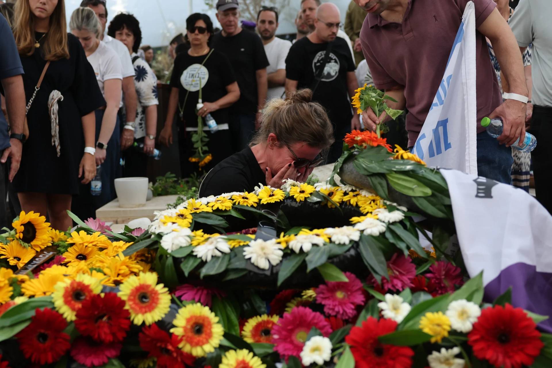 People mourn at the grave of Hadar Goldin an Israeli soldier killed in Gaza in 2014 and whose body had been held there until it was released Sunday, during his funeral in Kfar Saba, Israel, Tuesday, Nov. 11, 2025. (Credit: Abir Sultan/Pool via AP.)