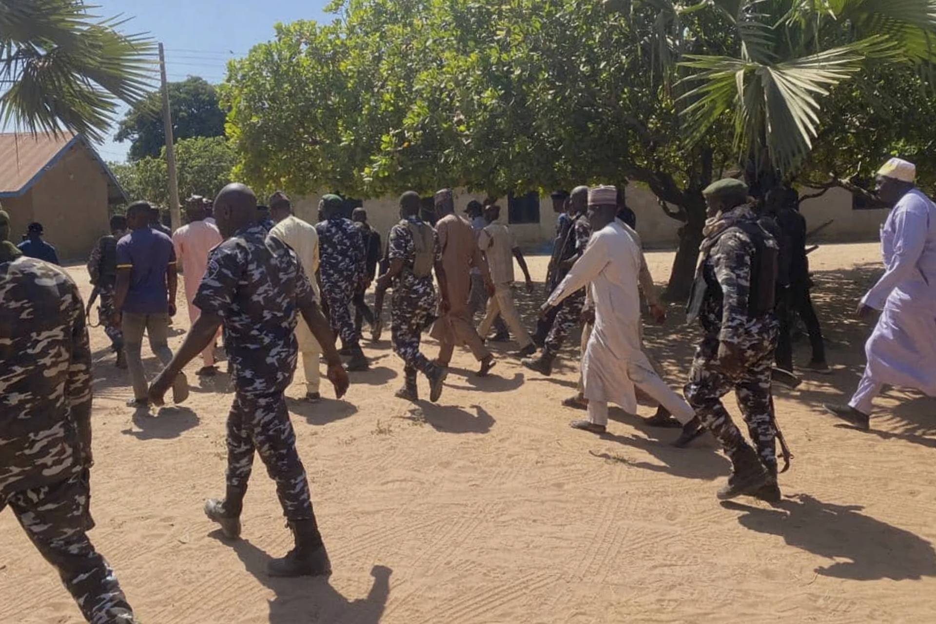 Police and government officials walk past St. Mary's Catholic Primary and Secondary School where gunmen on Friday abducted children and staff in Papiri community, Nigeria, on Nov. 25, 2025. (Credit: Yunusa Umar/AP.)