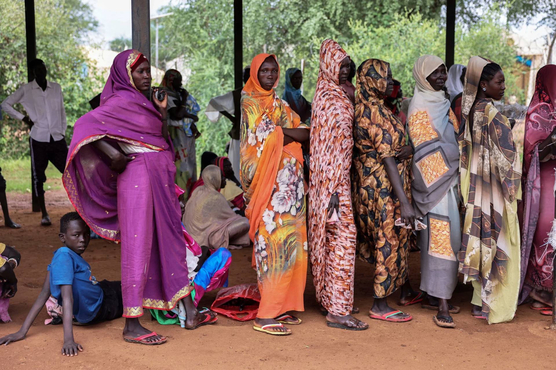 Women wait for cash assistance and dry grain from the U.N. World Food Program in Gendrassa refugee camp, Maban, South Sudan, on Aug. 20, 2025. (Credit: Caitlin Kelly/AP.)