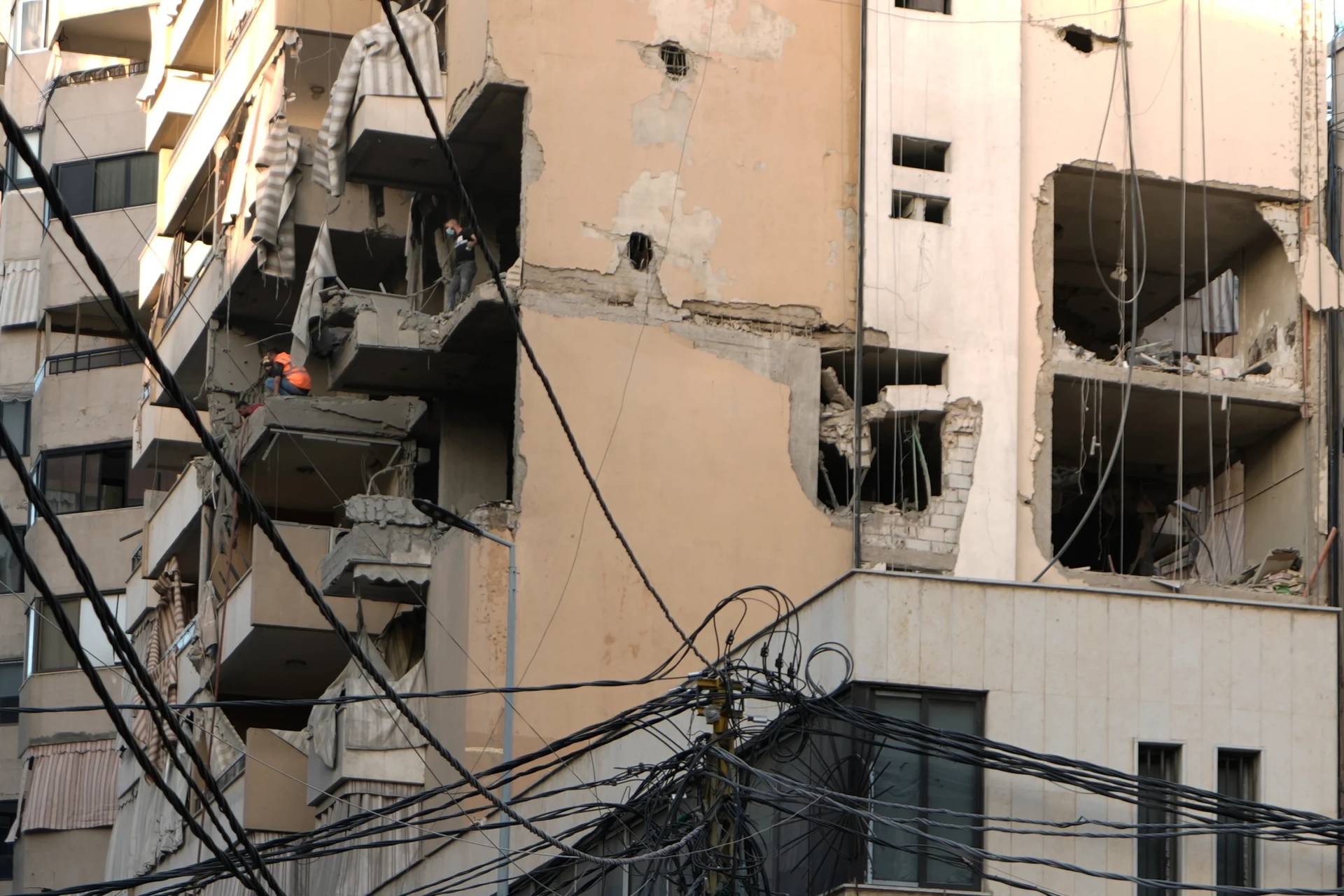 Civil Defence workers inspect the damage after an apartment was hit during an Israeli airstrike on Dahiyeh in the southern suburb of Beirut, Sunday Nov. 23, 2025. (Credit: Bilal Hussein/AP.)