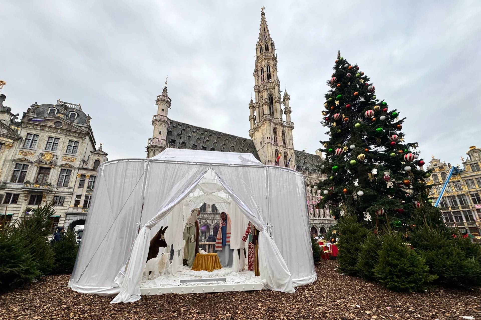 A Nativity scene containing characters with cloth faces, by Belgian artist Victoria-Maria Geyer, is displayed in a white tent in Brussels, Monday, Dec. 1, 2025. (Credit: Sylvain Plazy/AP.)