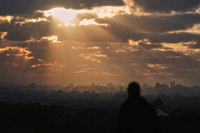 A Palestinian looks over an area of buildings destroyed during Israeli air and ground operations at sunset in northern Nuseirat, central Gaza Strip, Friday, Dec. 19, 2025. (Credit: Abdel Kareem Hana/AP.)