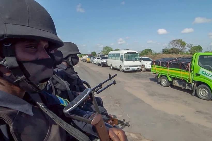 In this image made from video, Rwandan police patrol a road in Palma, Cabo Delgado province, Mozambique Sunday, Aug. 15, 2021. (Credit: Marc Hoogsteyns/AP.)