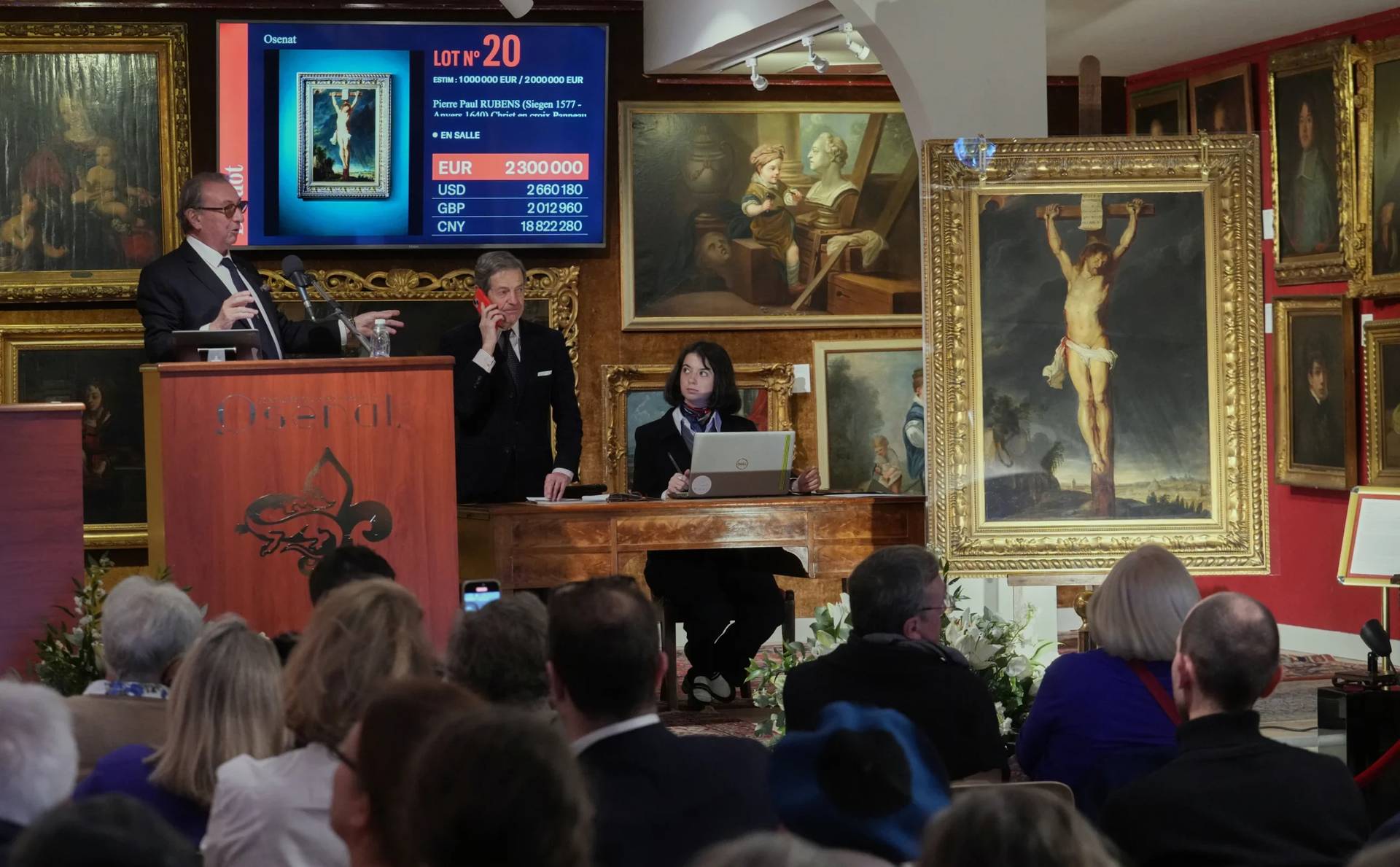 Auction officer Jean-Pierre Osenat gestures as the long-lost painting “Crucifixion of Jesus Christ” by Baroque master Peter Paul Rubens was sold at auction for 2,3 million euros or $2.66 million in Versailles, west of Paris, Nov. 30, 2025. (Credit: Michel Euler/AP.)