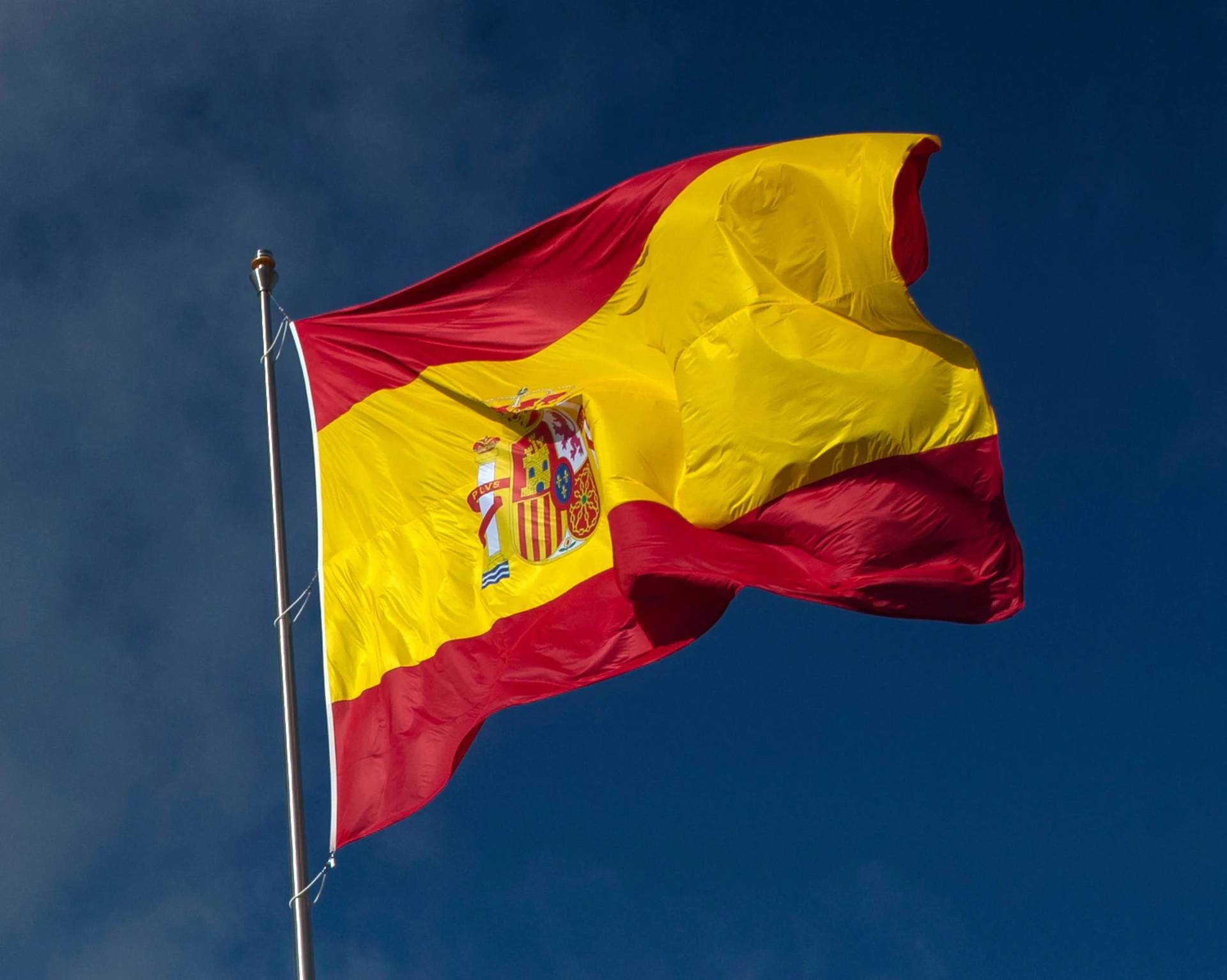 The Spanish flag flies during a memorial for coronavirus (COVID-19) victims in Madrid, Spain, Friday, Oct. 23, 2020. (Credit: Manu Fernandez/AP.)