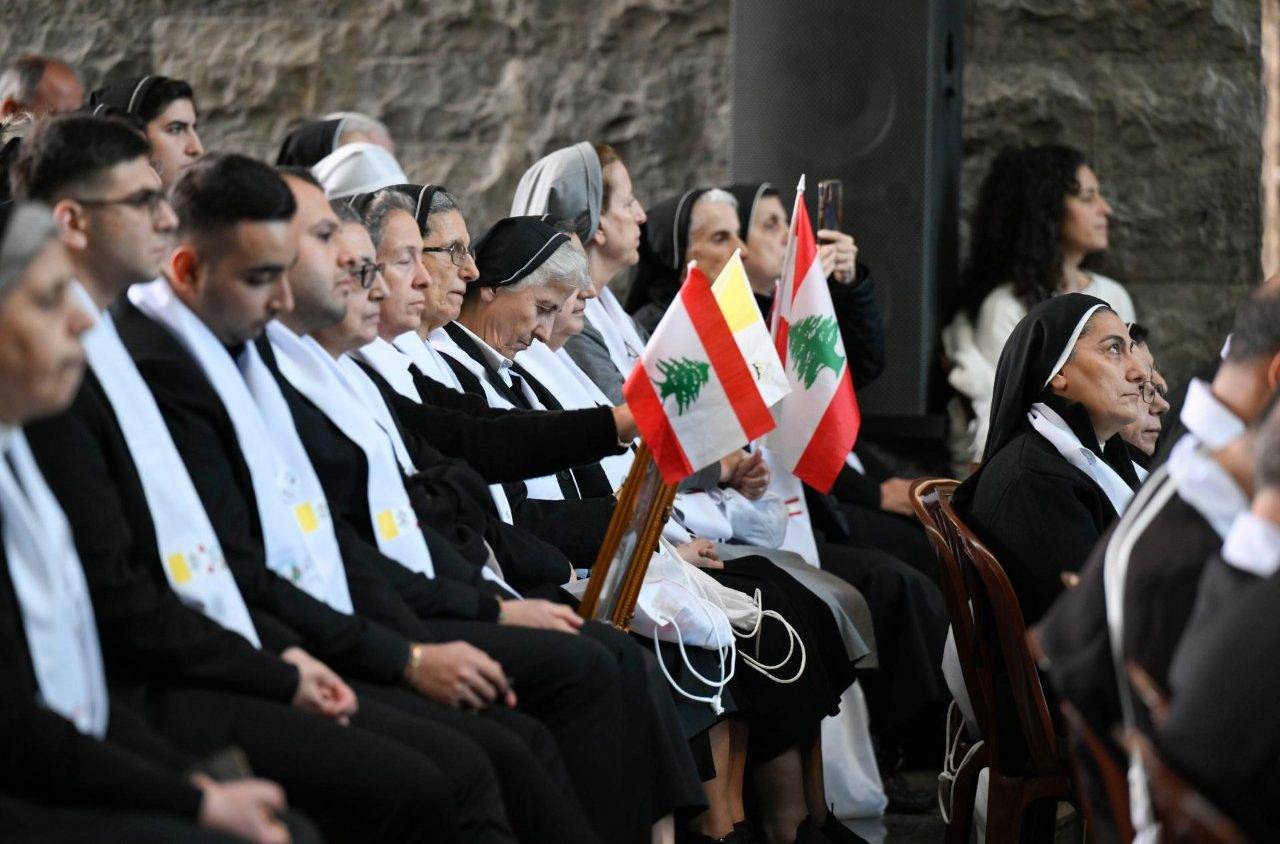 A group of nuns hold flags while waiting for the arrival of Pope Leo XVI to a meeting with bishops, clergy, religious and pastoral workers in Lebanon at the Shrine of Our Lady of Lebanon in Harissa, Dec. 1, 2025. (Credit: Vatican Media.)