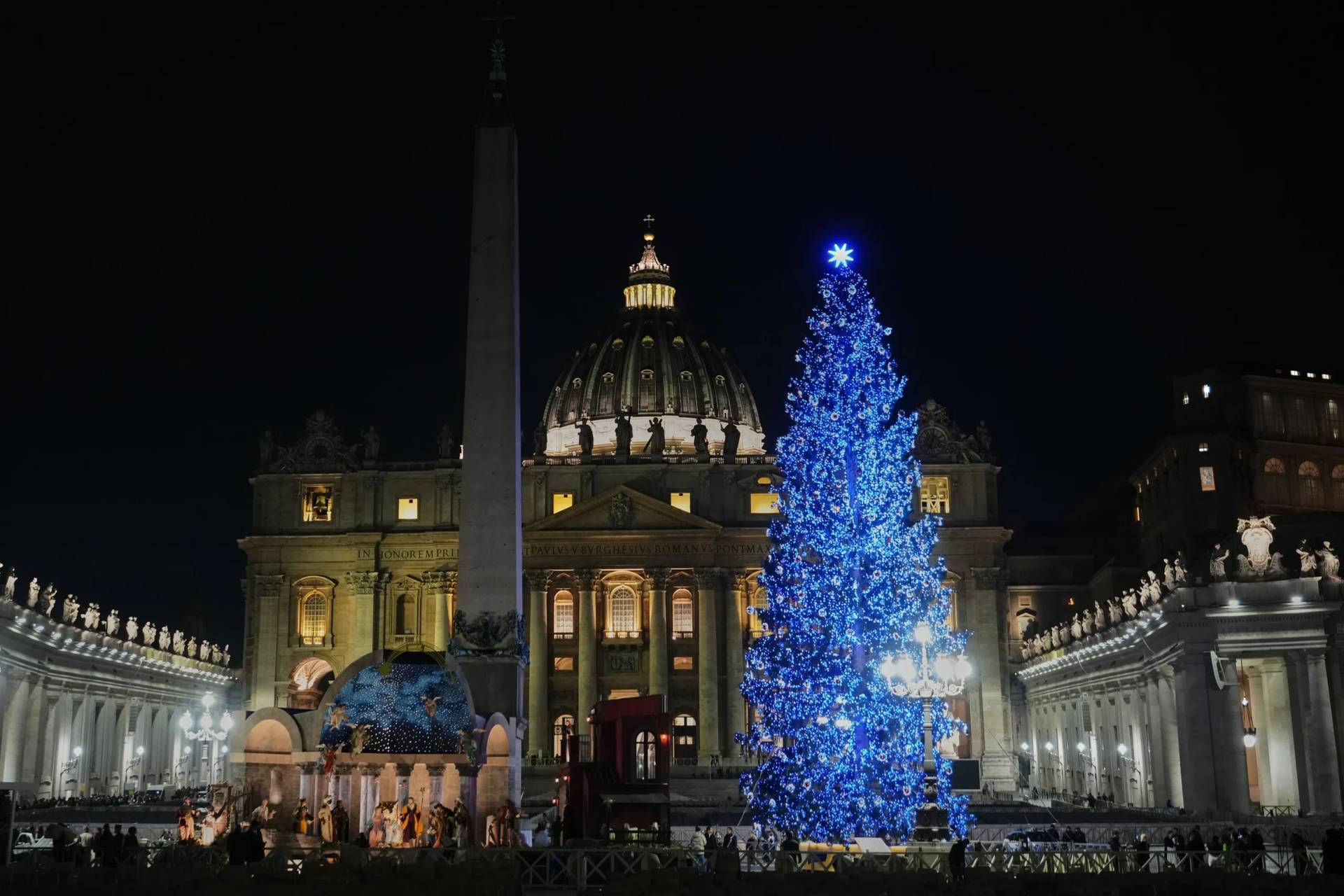 An 82-foot fir tree from the Ultimo valley in South Tyrol, Italy, is lit up as Christmas tree together with a crib in St. Peter’s Square at the Vatican, Monday, Dec. 15, 2025. (Credit: Alessandra Tarantino/AP.)