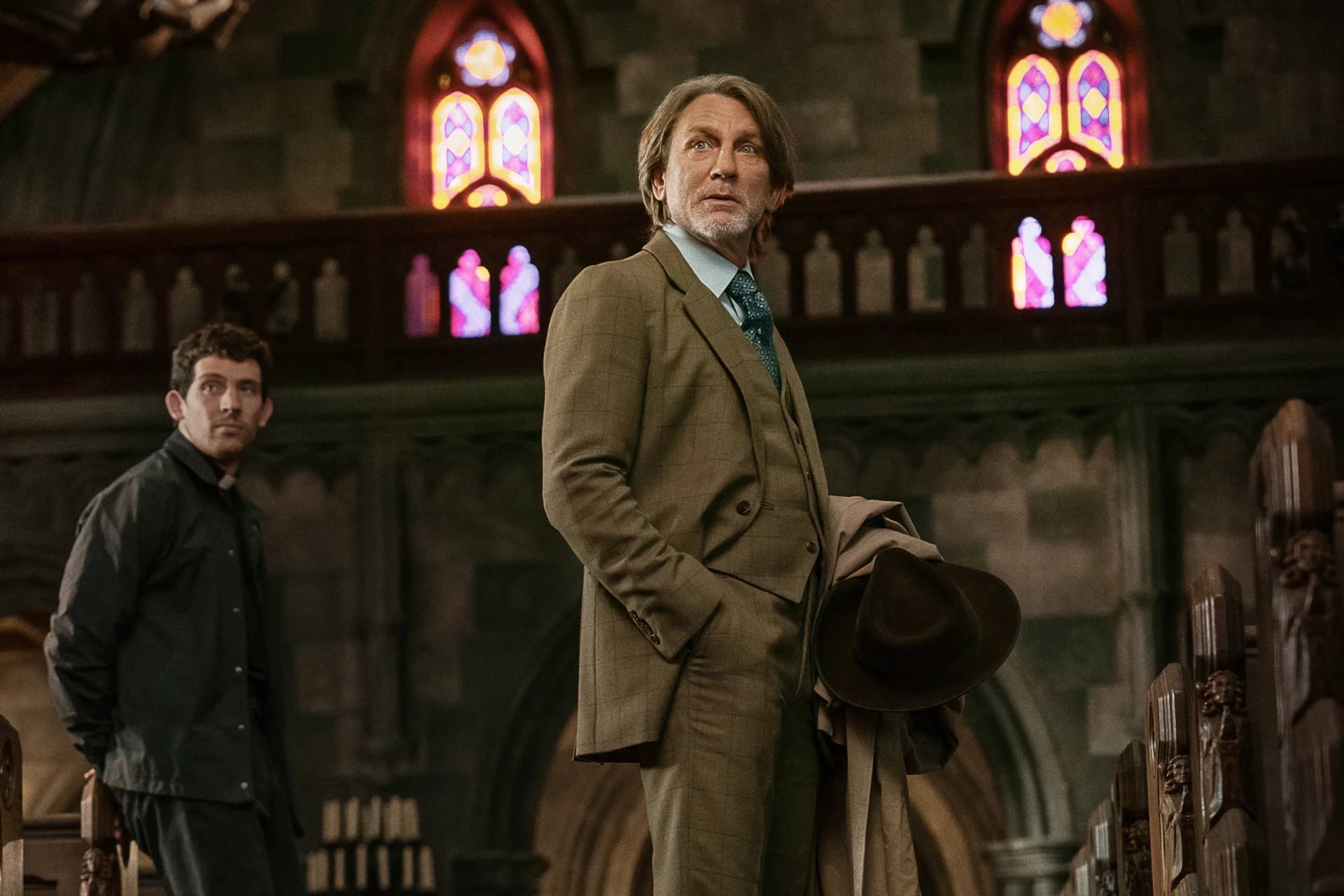 This image released by Netflix shows Josh O'Connor, left, and Daniel Craig in a scene from "Wake Up Dead Man: A Knives Out Mystery."(Credit: John Wilson/Netflix via AP.)