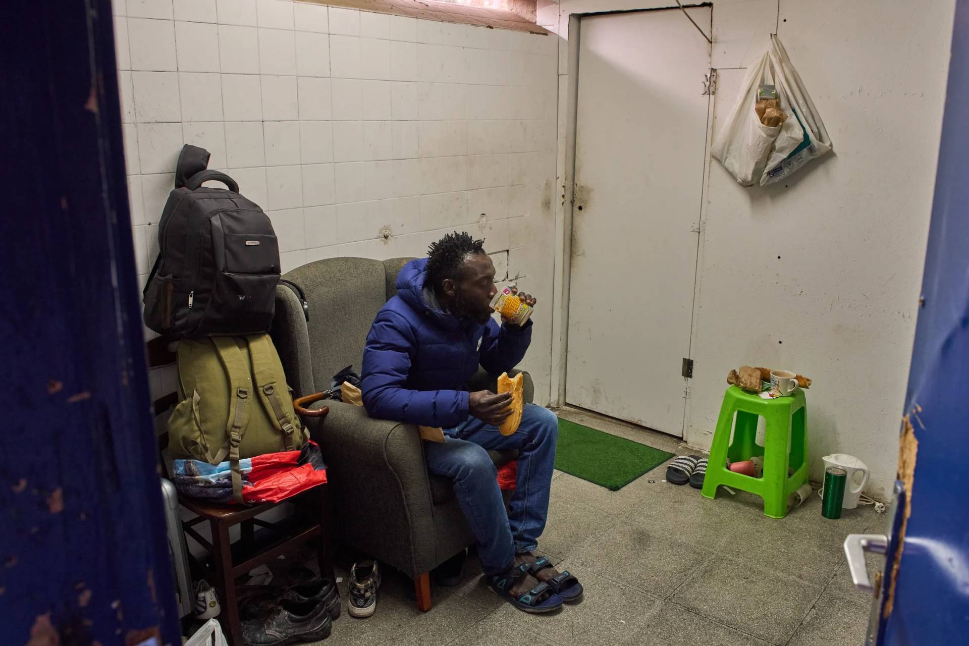 Yankuba Touray, from Gambia, eats his breakfast in an abandoned school in Badalona, near Barcelona, Spain, on Dec. 16, 2025. (Credit: Emilio Morenatti/AP.)