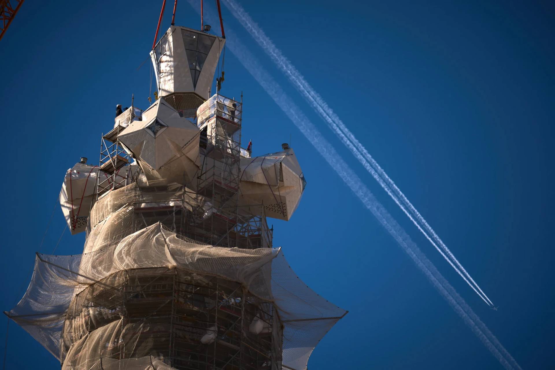 A crane lifts the upper arm of the cross onto the Tower of Jesus Christ at the Sagrada Familia in Barcelona, Spain, Friday, Feb. 20, 2026, reaching the basilica's maximum height of 566 feet. (Credit: Emilio Morenatti/AP.)