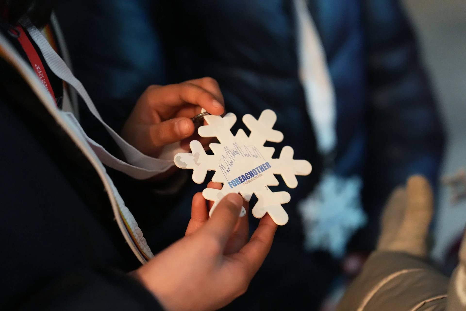 Children receive snowflake-shaped medals inspired by the 2026 Winter Olympics during an activity organized by a parish oratory connected to the Church of Santa Eufemia in Milan, Italy, Monday, Feb. 9, 2026. (Credit: María Teresa Hernandez/AP.)