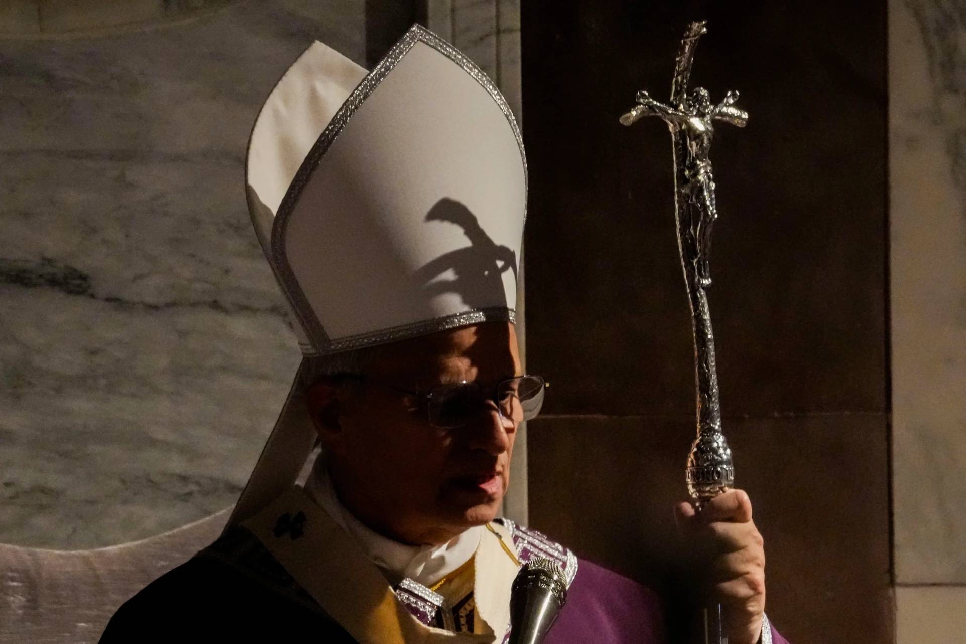 The shadow of the crucifix surmounting his pastoral staff falls across Pope Leo XIV as he presides over Ash Wednesday Mass, marking the start of Catholic Lent, inside the Basilica of Santa Sabina in Rome, Wednesday, Feb. 18, 2026. (Credit: Gregorio Borgia/AP.)