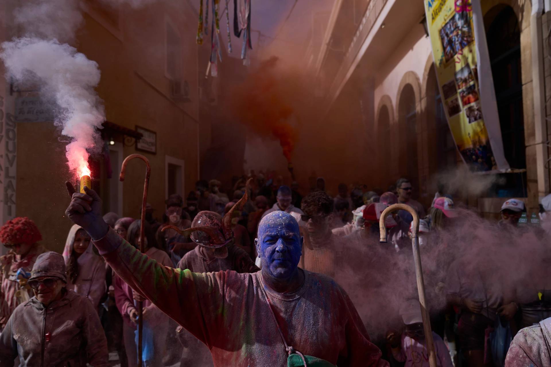 Revelers take part in the annual flour war marking the end of the Carnival season on Clean Monday in Galaxidi, about 200 kilometers (120 miles) west of Athens, Monday Feb. 23, 2026, starting the 40-day Christian Lent fast leading to Easter. (Credit: Petros Giannakouris/AP.)