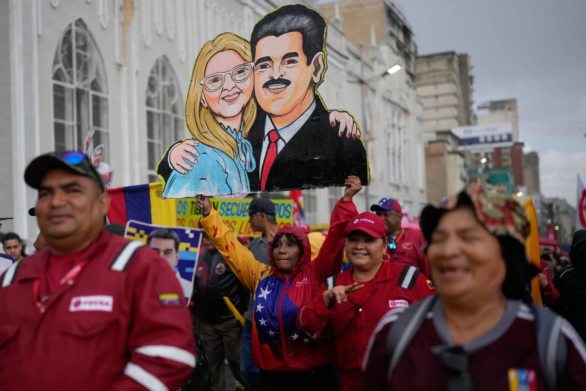 Government supporters carry a cutout of former President Nicolás Maduro and his wife Cilia Flores during a rally marking the anniversary of the 1958 coup that overthrew Venezuelan dictator Marcos Pérez Jiménez, in Caracas, Venezuela, Jan. 23, 2026. (Credit: Ariana Cubillos/AP.)