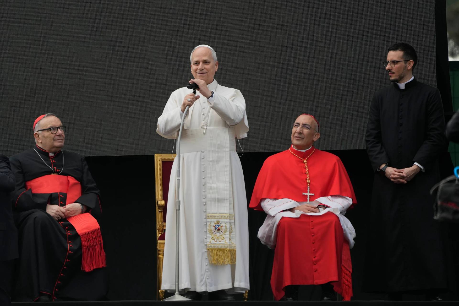 Cardinal Francesco Montenegro, left, and from right, Father Paolo Stacchiotti and Cardinal Baldo Reina listen to Pope Leo XIV during a visit to the parish complex of Santa Maria della Presentazione on the outskirts of Rome, Sunday, March 8, 2026. (Credit: Gregorio Borgia/AP.)