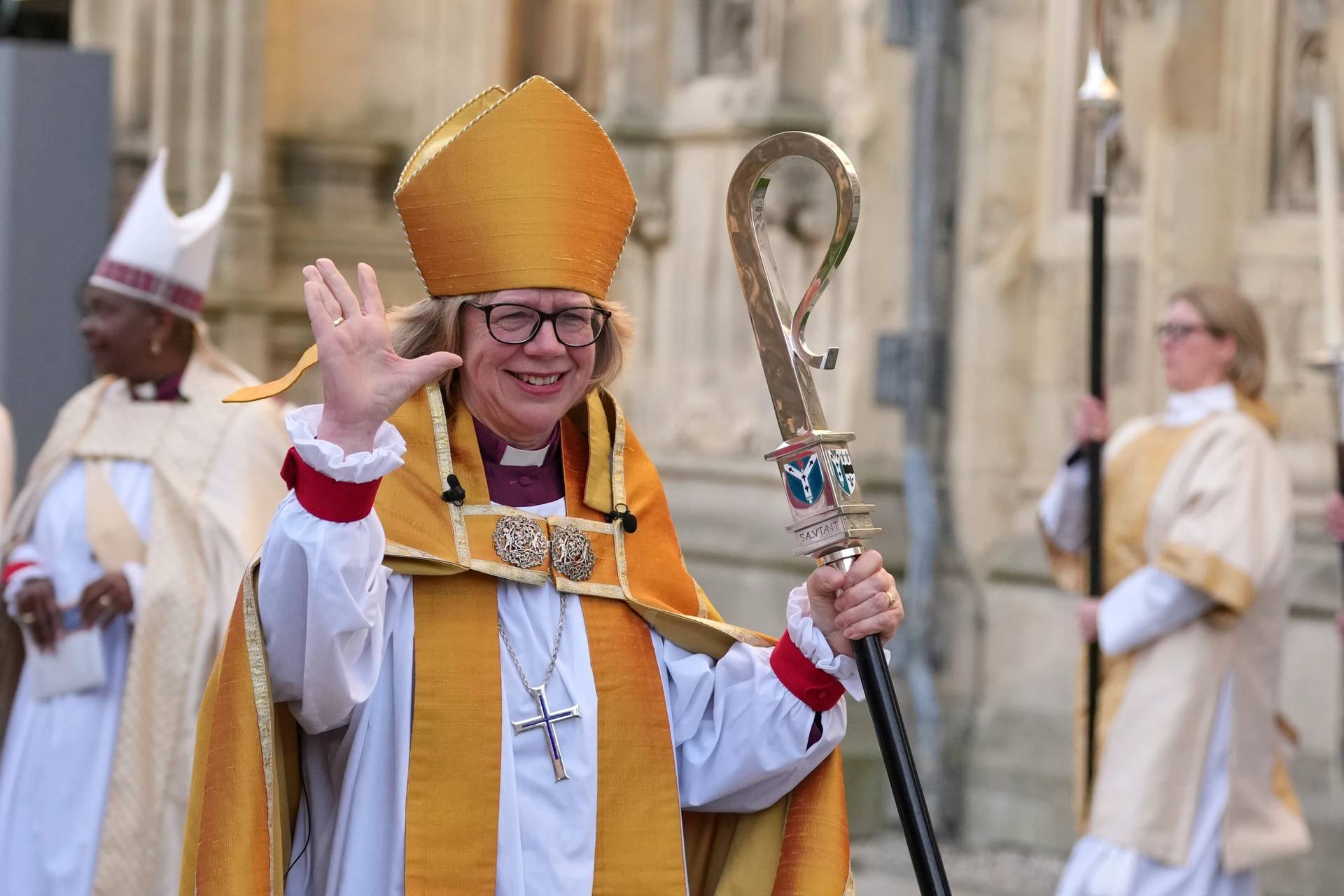 Sarah Mullally waves as she leaves after the Enthronement Ceremony installing her as archbishop of Canterbury in Canterbury, England, Wednesday, March 25, 2026, the first woman ever to lead the Church of England. (Credit: Alastair Grant/AP.)