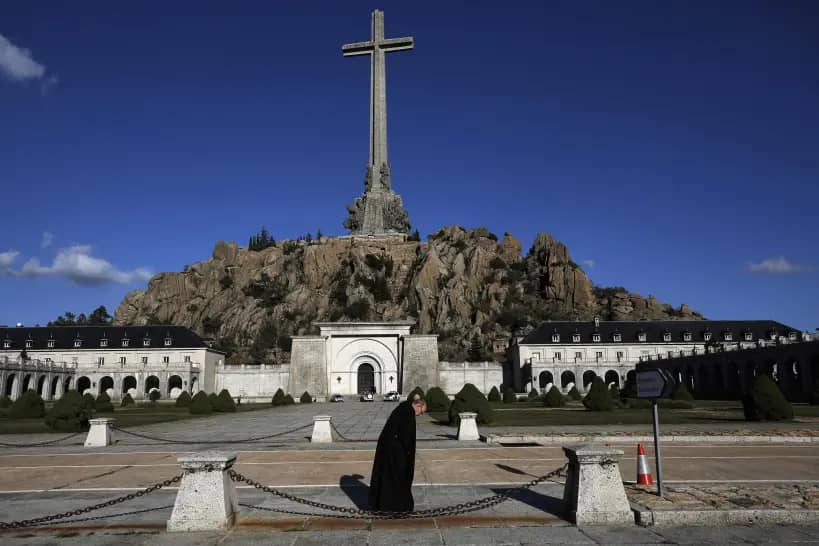 A friar walks in front of the Valle de los Caidos (Valley of the Fallen) mausoleum on the outskirts of Madrid, Spain, on Oct. 13, 2019. (Credit: Manu Fernandez/AP.)
