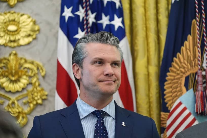 Defense Secretary Pete Hegseth listens as President Donald Trump speaks during the swearing in for Homeland Security Secretary Markwayne Mullin in the Oval Office of the White House, Tuesday, March 24, 2026, in Washington. (Credit: Alex Brandon/AP.)