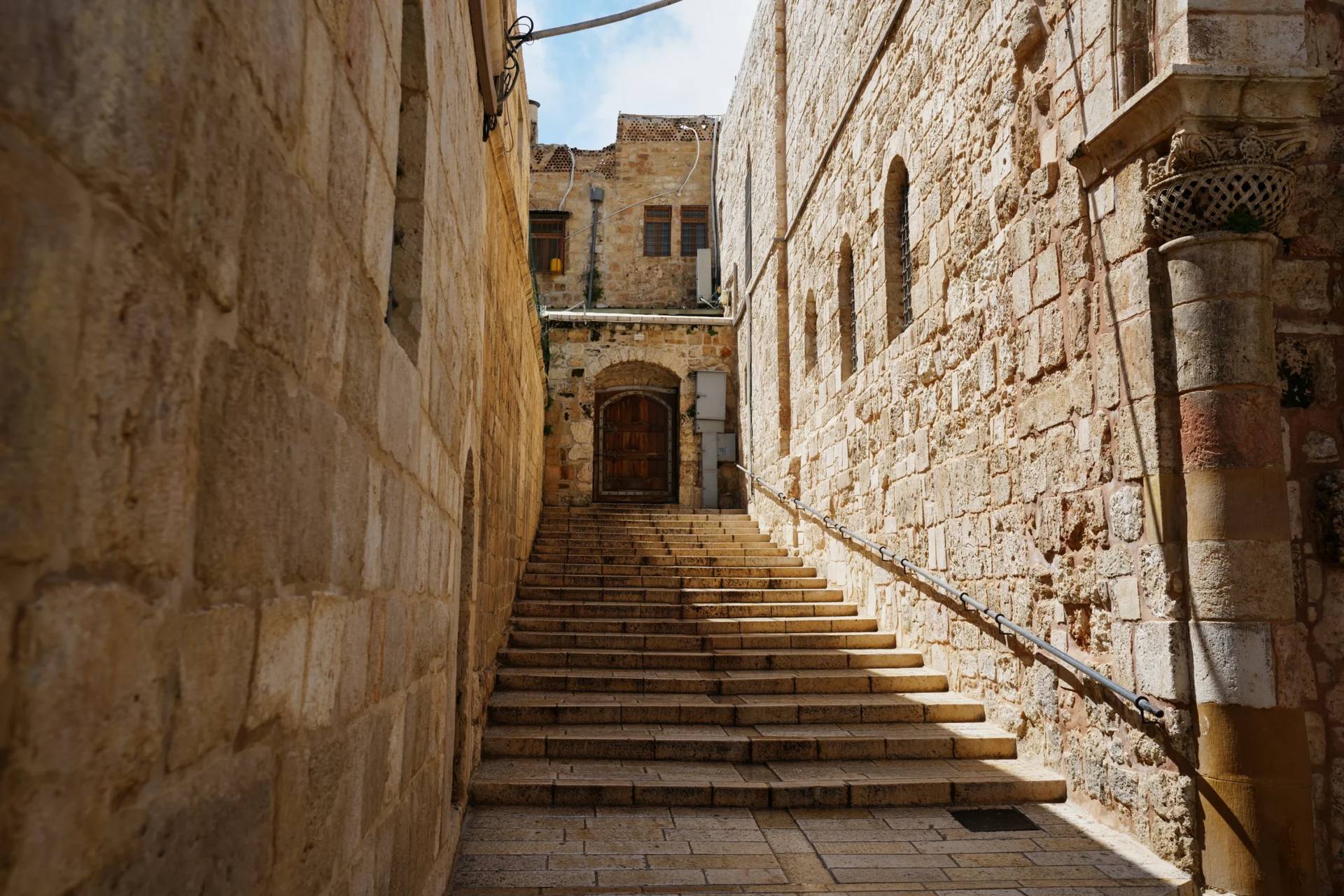 A locked door and empty stairs leading to the Church of the Holy Sepulchre in Jerusalem's Old City, closed to visitors amid heightened security during the war with Iran, Friday, March 27, 2026. (Credit: Mahmoud Illean/AP.)
