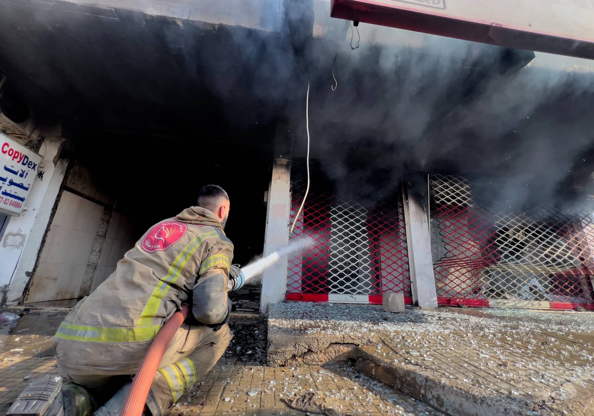 A firefighter extinguishes a burned shop at a building that was hit by an Israeli airstrike in Dahiyeh, a southern suburb of Beirut, Lebanon, Tuesday, March 3, 2026. (Credit: Hussein Malla/AP.)
